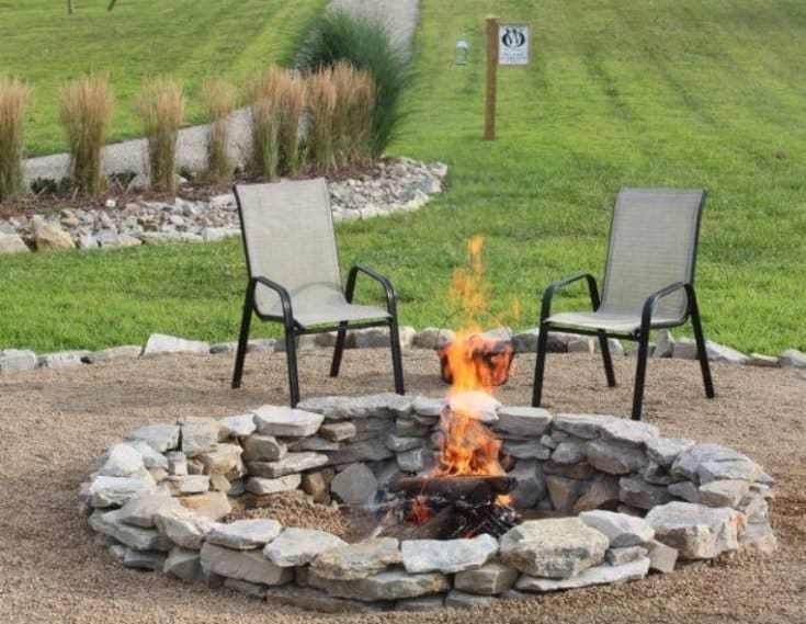 Stacked Stone Fire Pit in the middle of two chairs outdoors